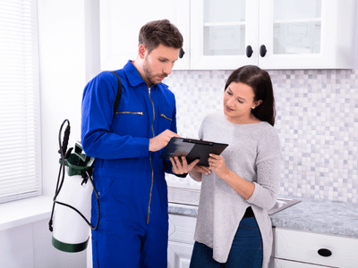 Pest Pro technician explaining a treatment plan to a San Antonio homeowner